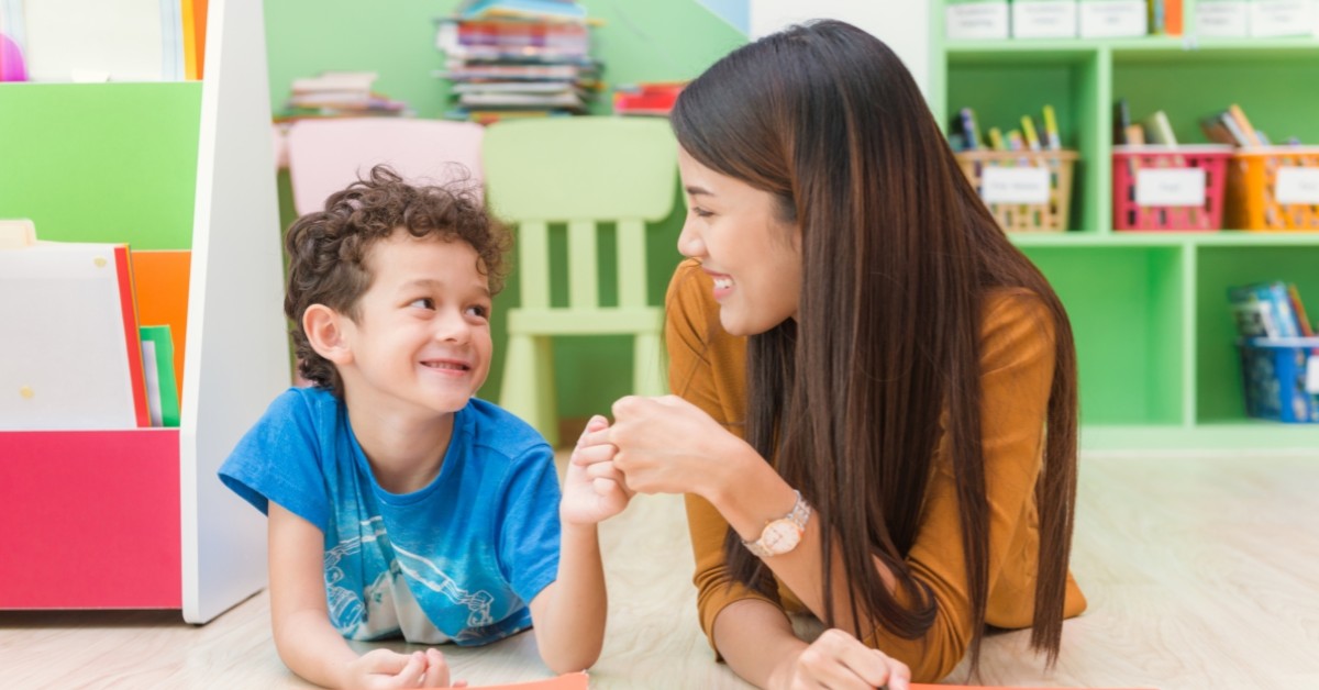 child and teacher fist-bumping