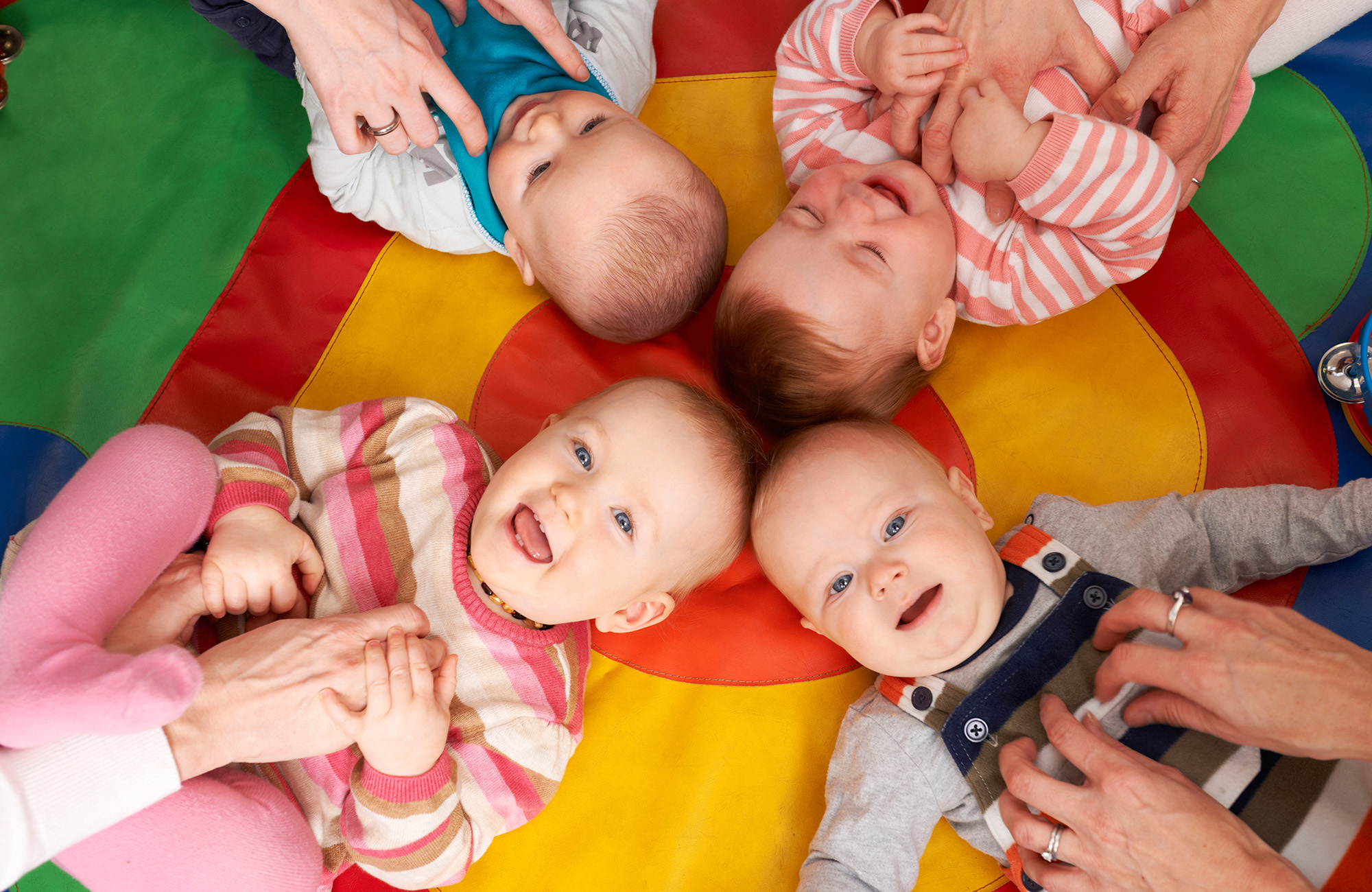 babies on colorful mat