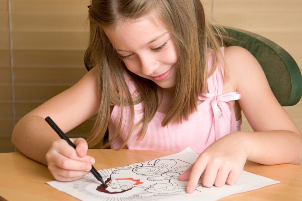 young girl coloring drawing of jesus