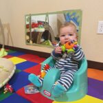 baby chewing on toy