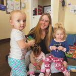 children wearing pajamas with teacher