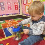 young boy playing on rug