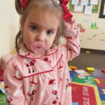 child in pajamas in classroom