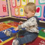 young boy playing on a rug