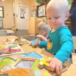 little kid playing with puzzle