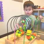 young boy playing with toy