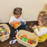 young girls playing with toys in classroom