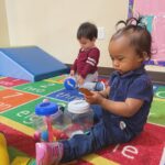 child playing with toy in classroom
