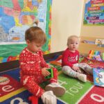 kids in christmas pajamas in classroom