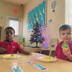 two boys eating cupcakes