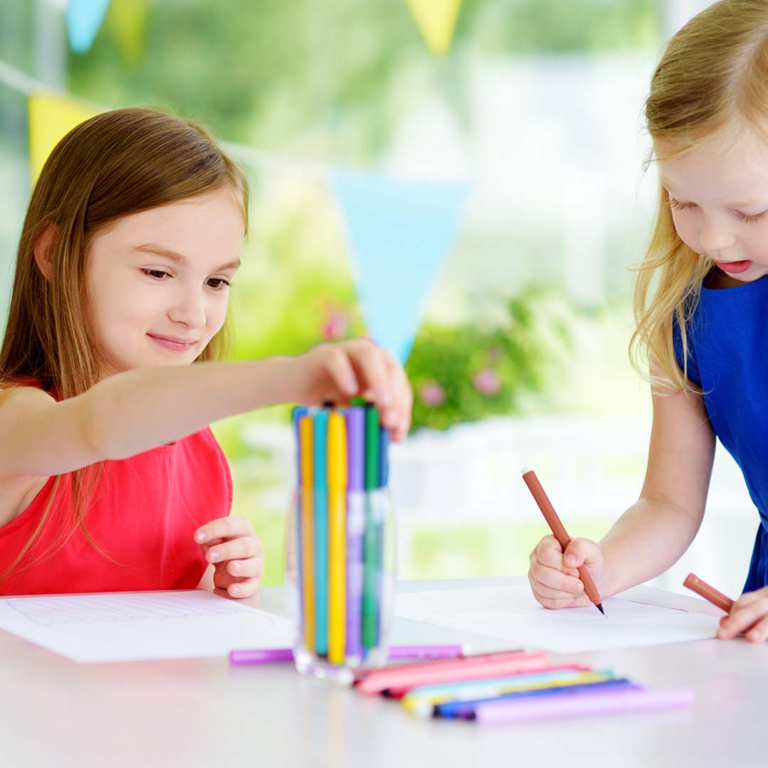 two girls coloring
