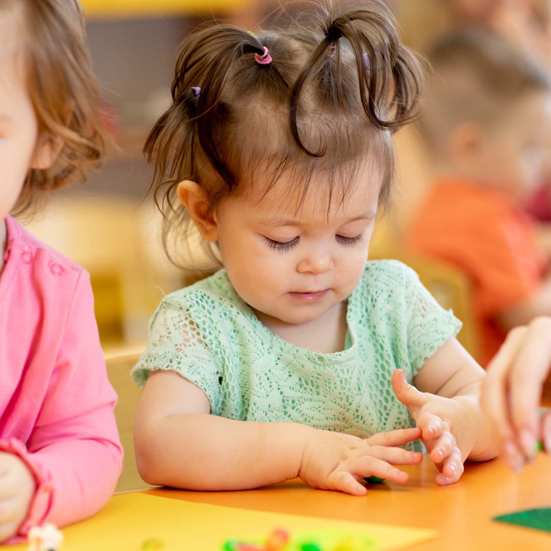 toddler playing at table