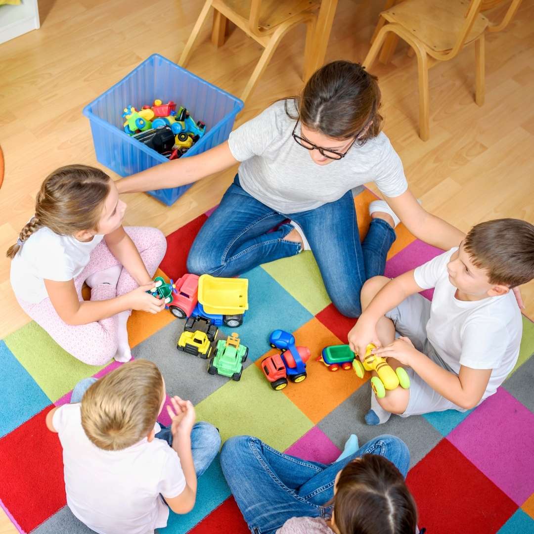 Teacher and children sitting in a circle and talking