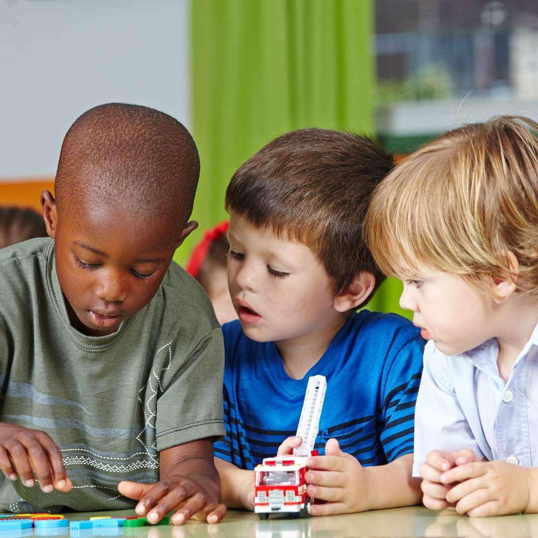 Children playing with toys at a desk