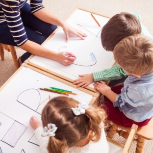 Group of preschoolers learning to write