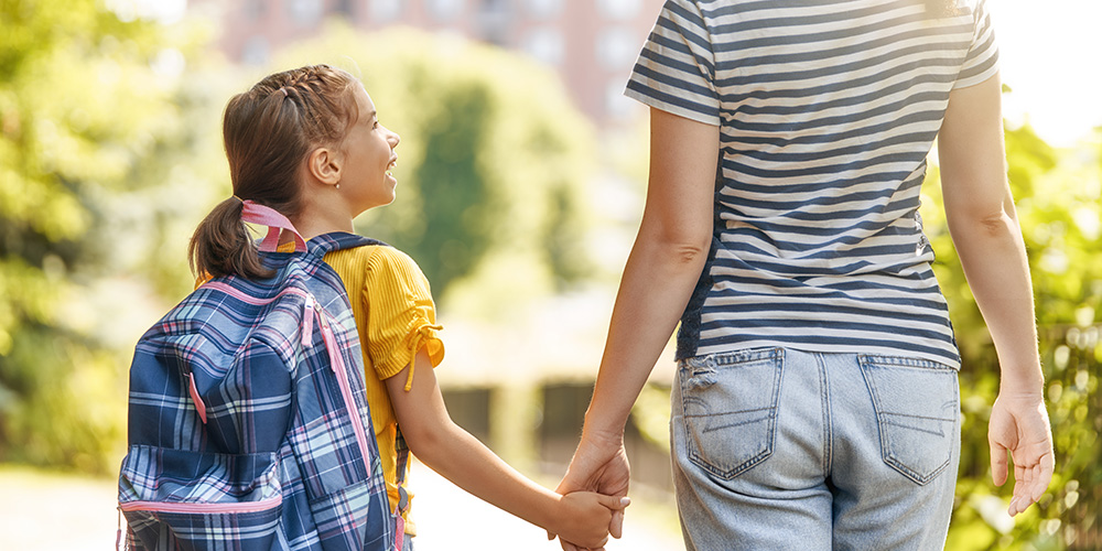 holding adult's hand on first day of school
