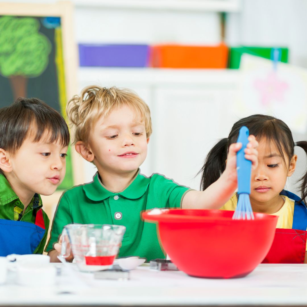 preschoolers whisking food or science experiment