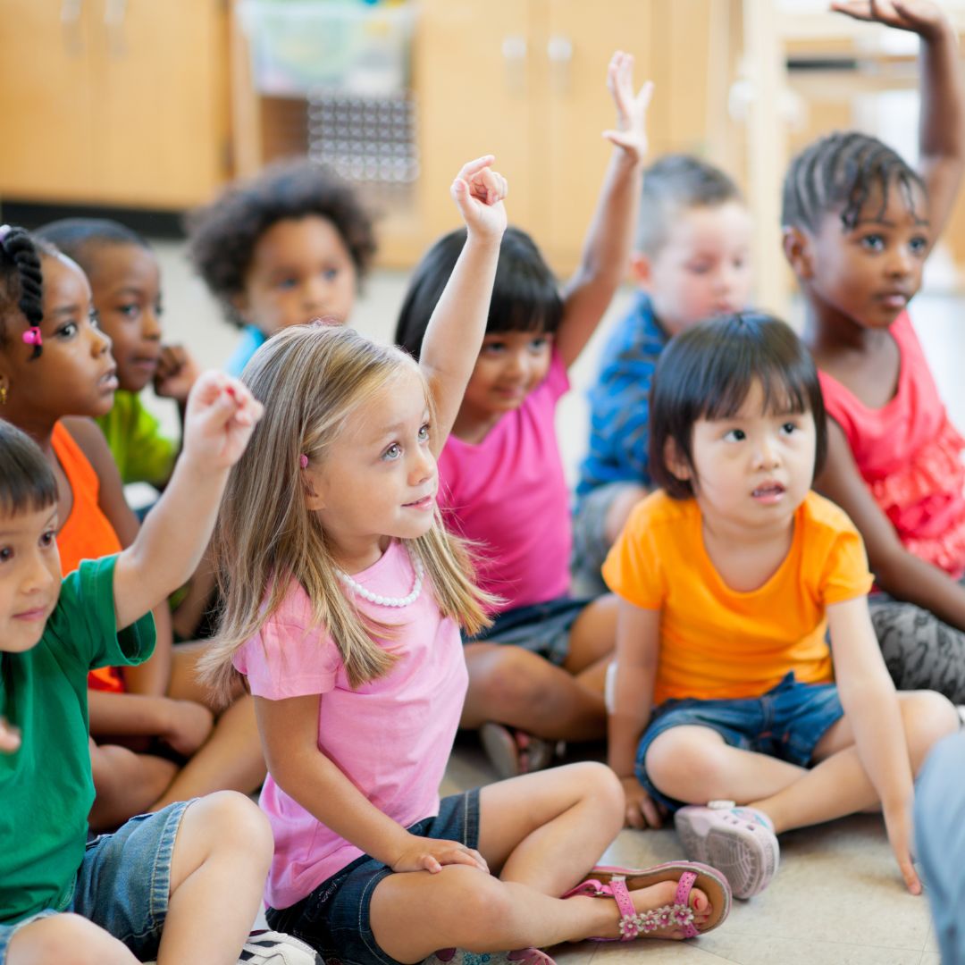 preschoolers raising hands