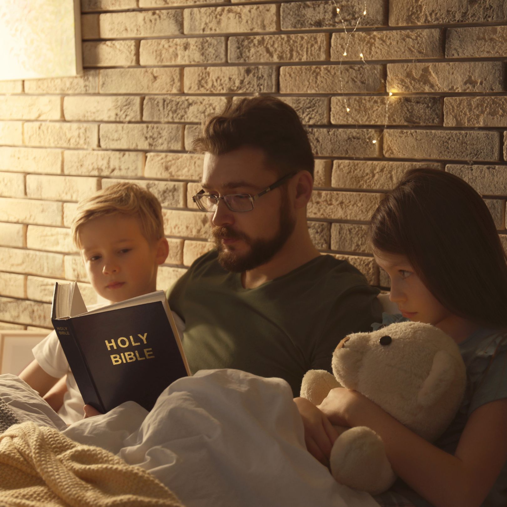 father reading children the bible