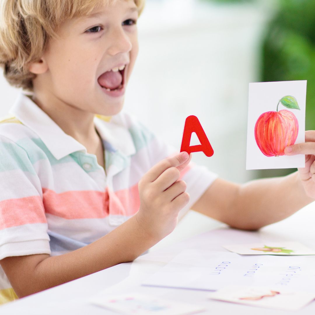 child learning connection between the letter "A" and the word "apple".