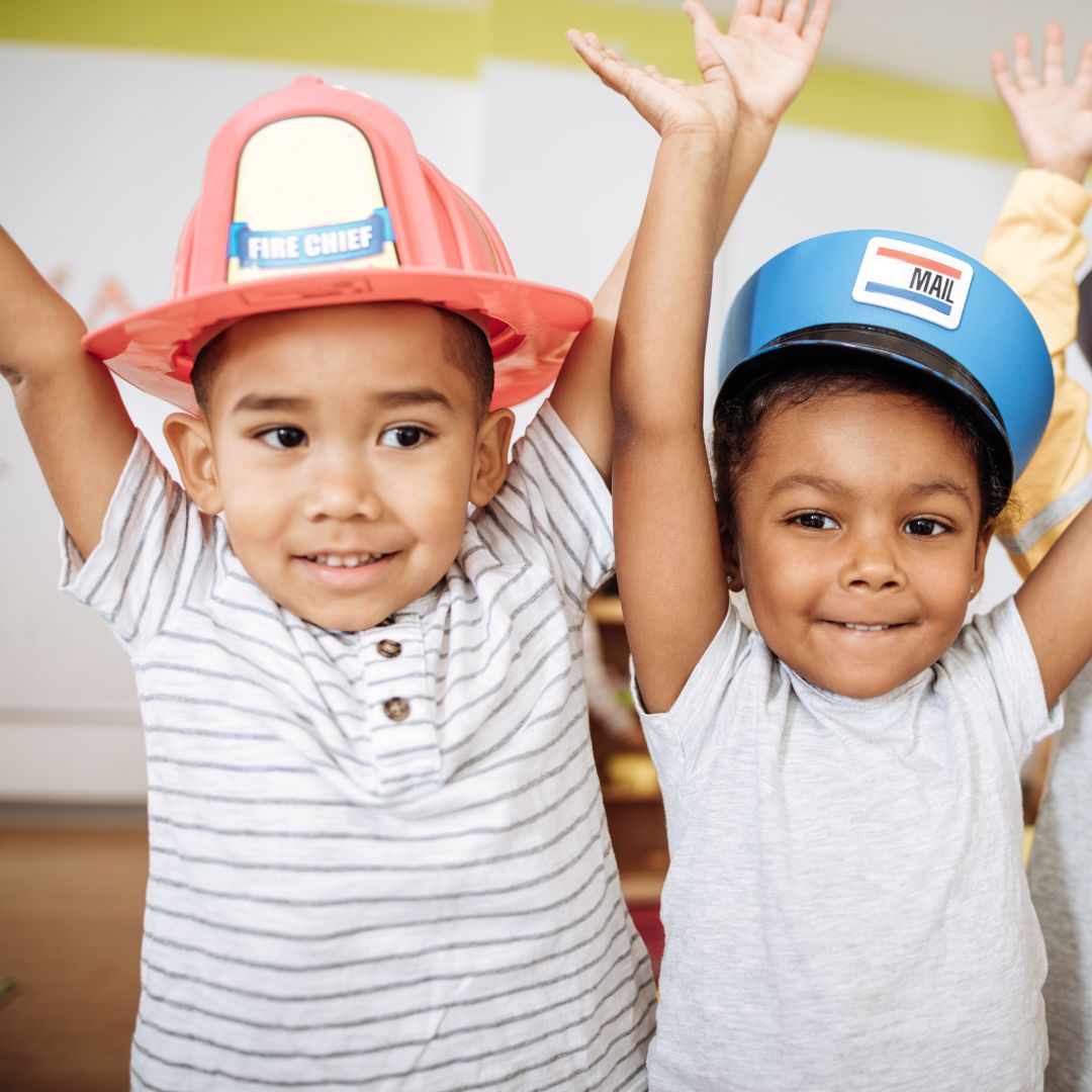 kids in fireman hat and mailman hat