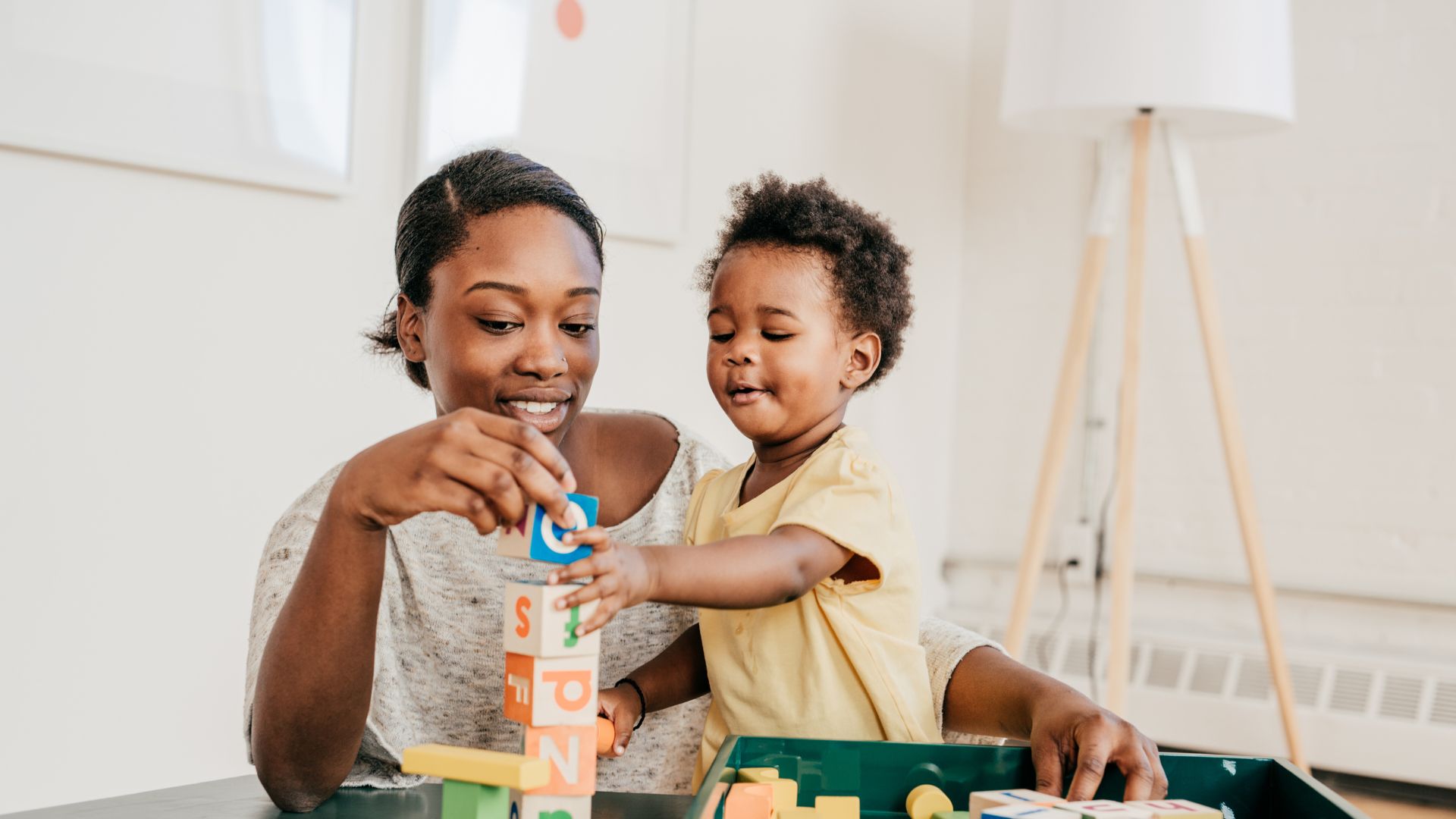 woman and child playing with blocks
