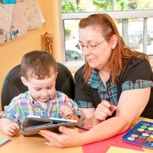 teacher showing a book to a child