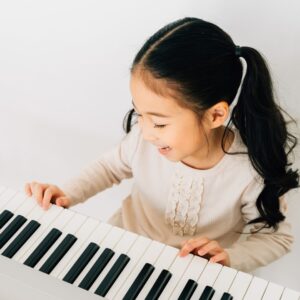preschooler playing piano