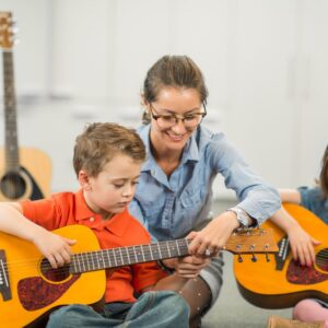 preschoolers playing guitars