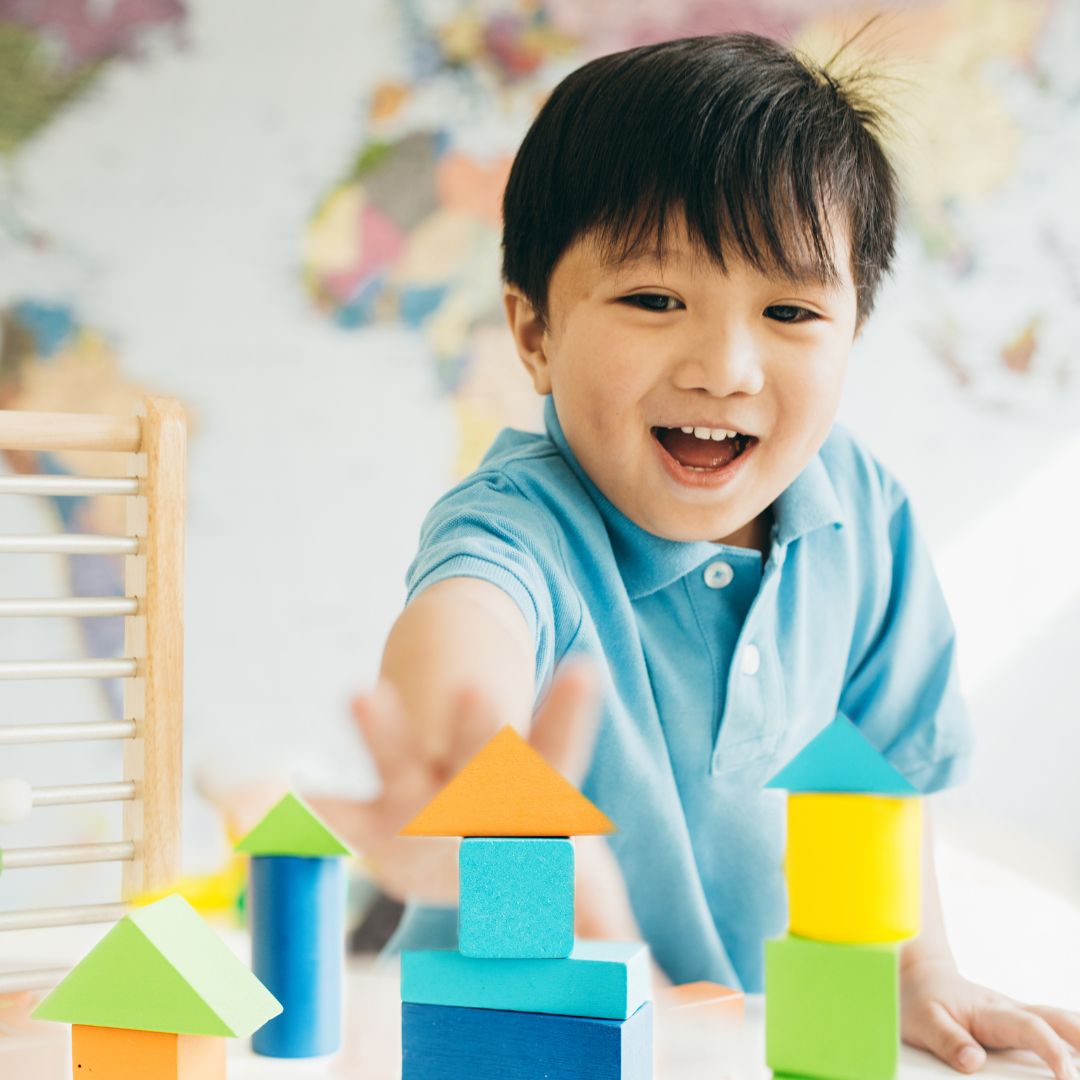 a child reaching for blocks