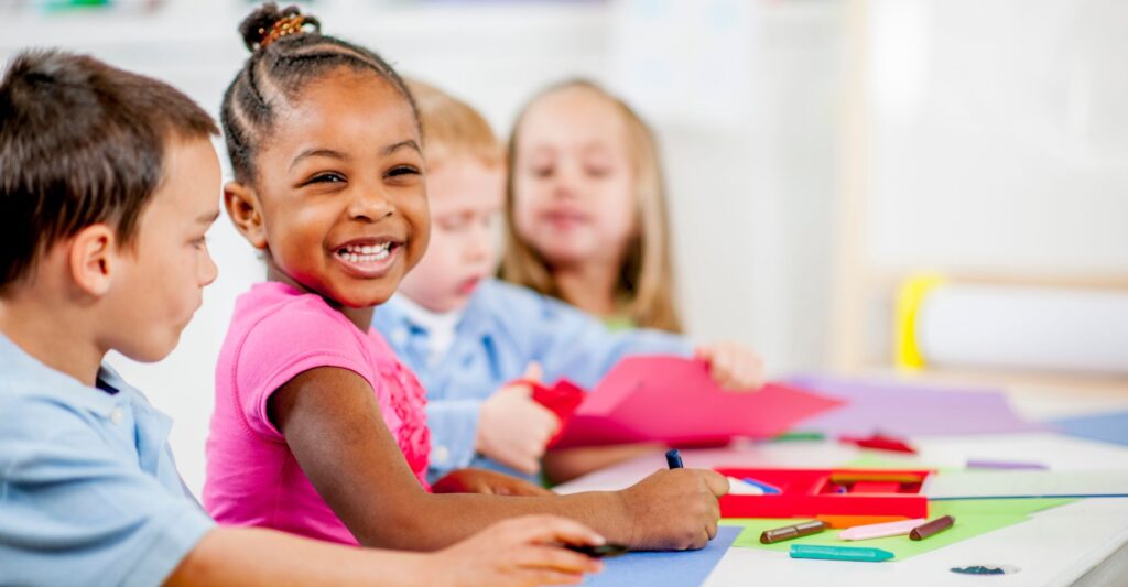 girl learning in classroom smiling