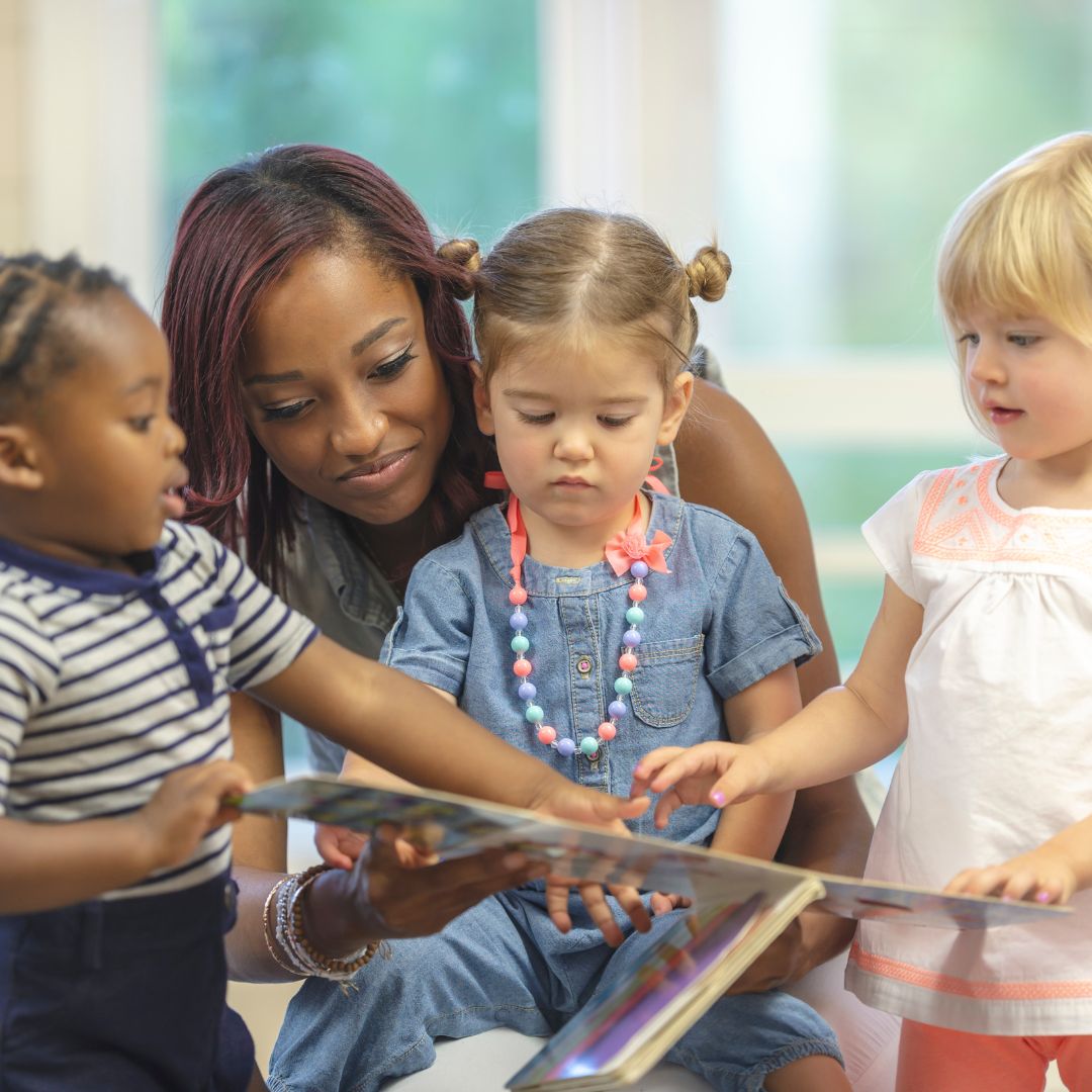 children reading book together