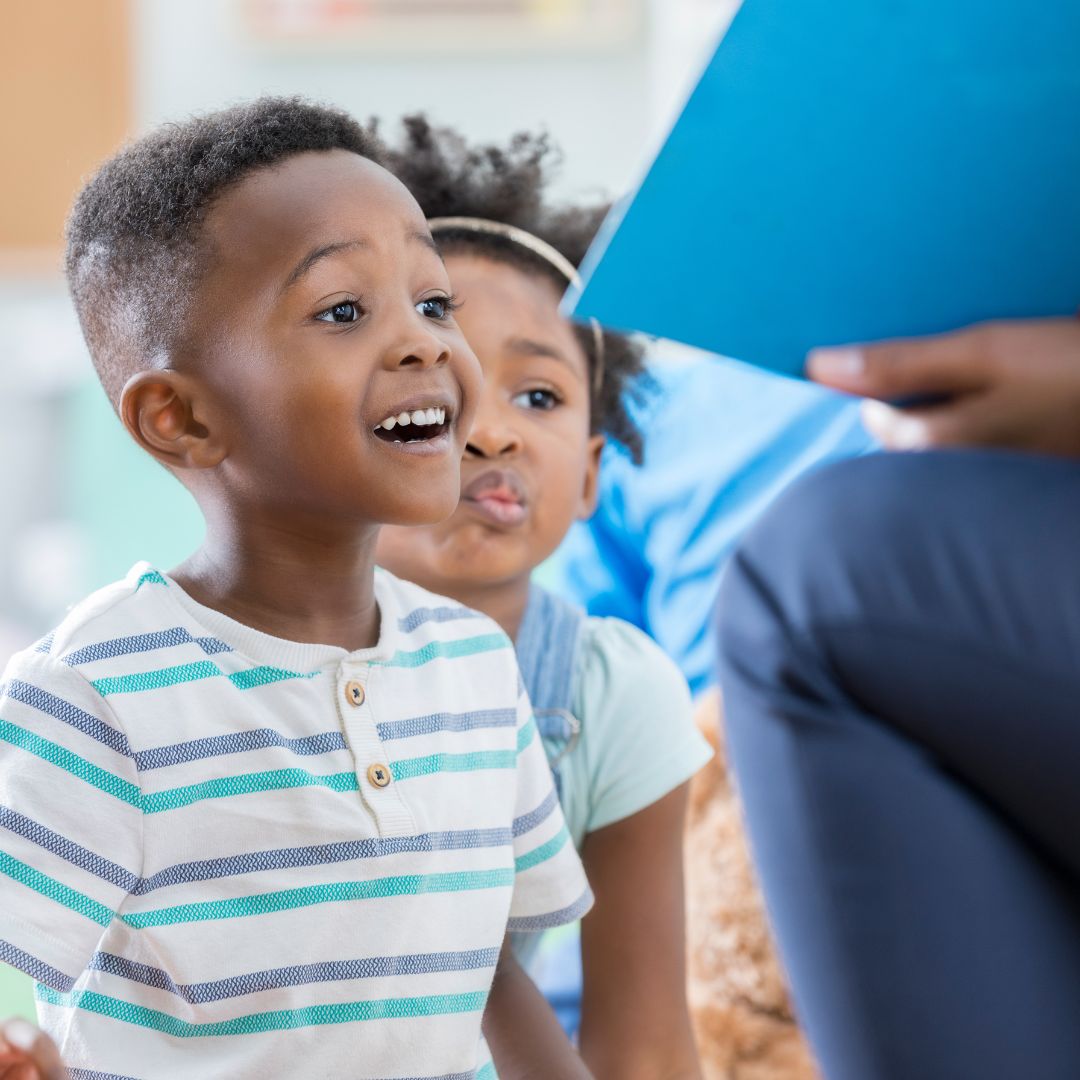child eagerly listening to teacher