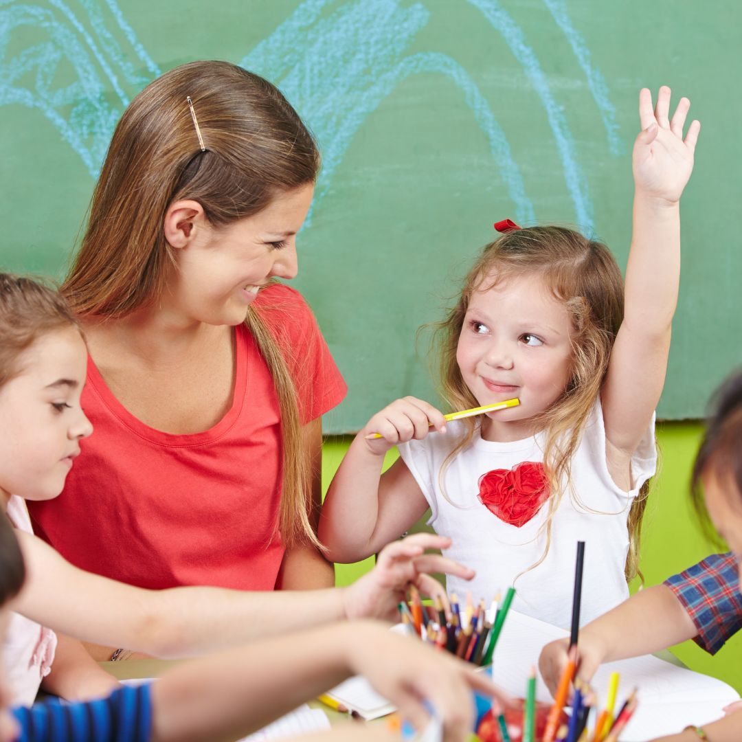 child raising hand in class