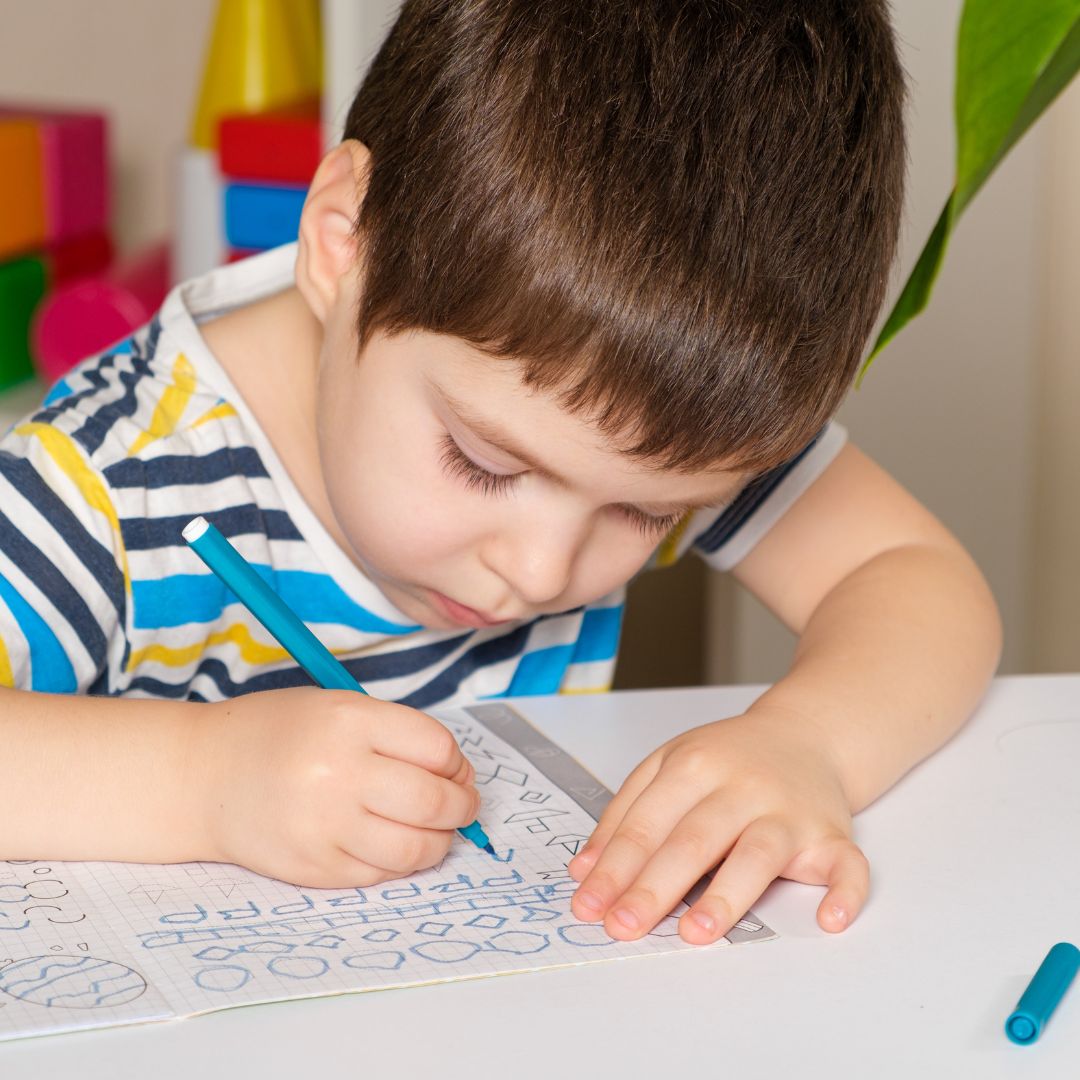 child practicing drawing shapes
