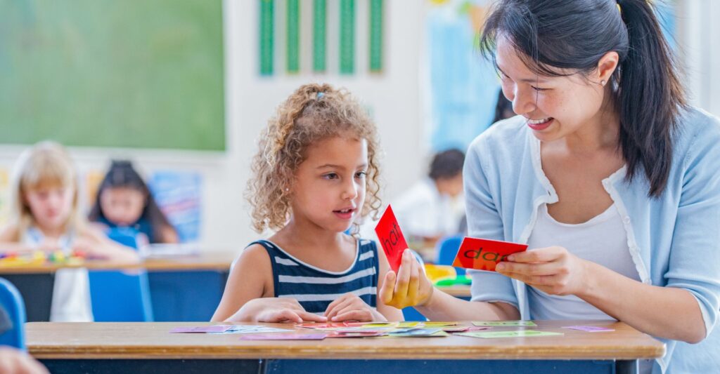 teacher and student with language cards