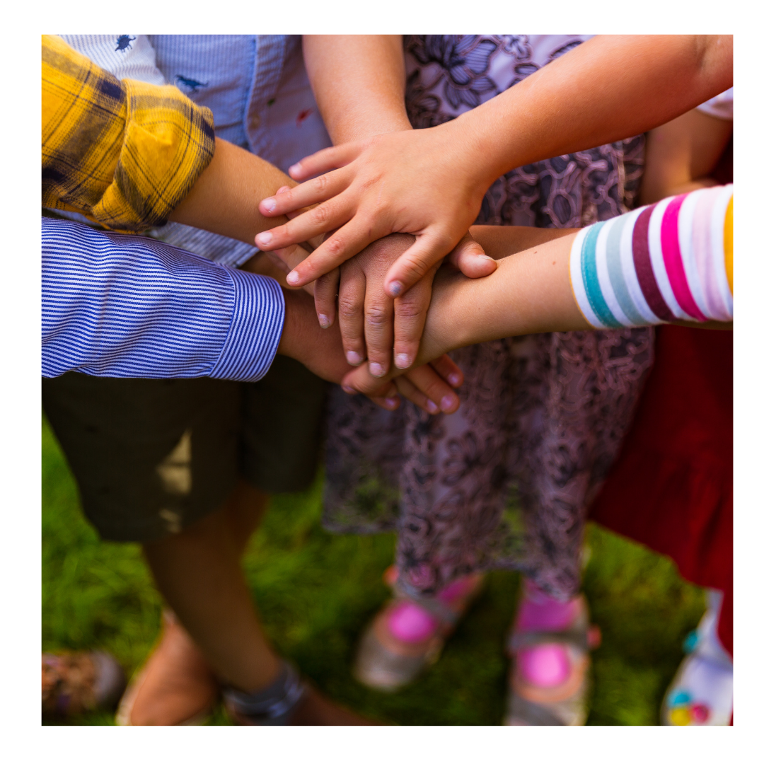 Kids putting their hands together