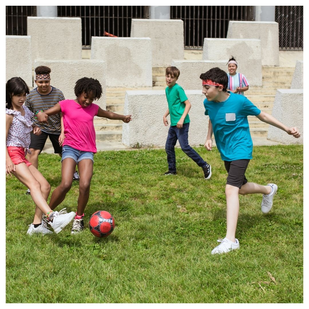 Kids playing soccer together