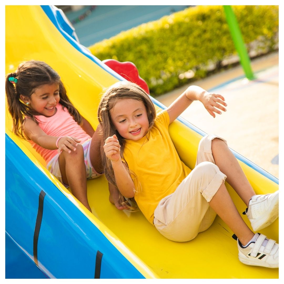 children going down the slide together