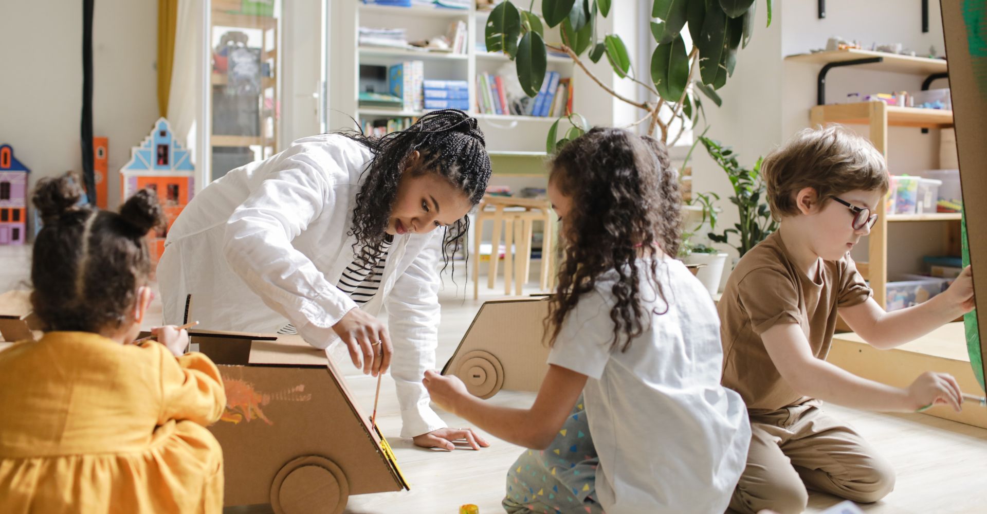 kids painting with their teacher