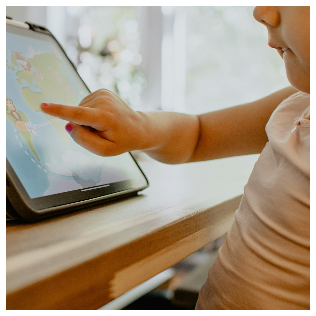 little kid learning on tablet