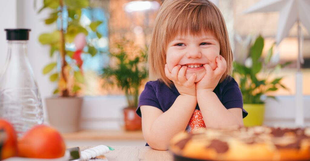 Young girl smiling at the dinner table