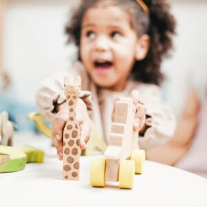 preschool girl engaging in play based learning at school