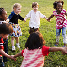 children holding hands outside