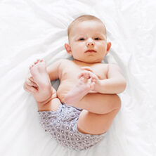baby laying on blanket